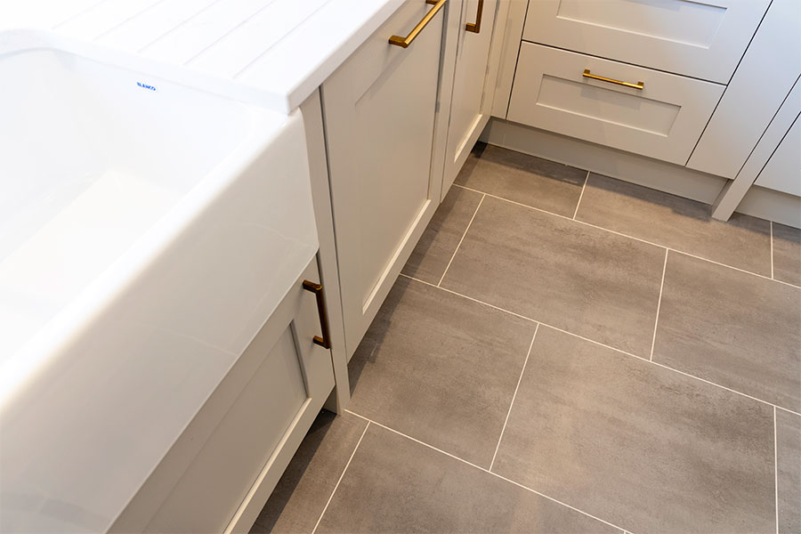 Amtico grey stone effect luxury vinyl flooring installed in a luxury kitchen display at Sussex Stoneworks in Midhurst