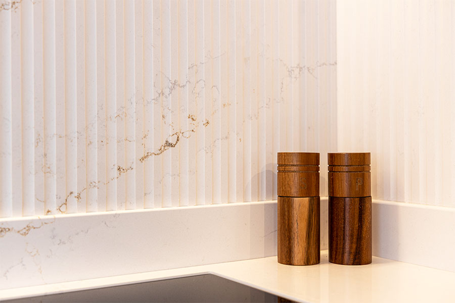 White marble effect Silestone splashback with ribbed detailing on display at the Sussex Stoneworks worktops showroom in Midhurst West Sussex