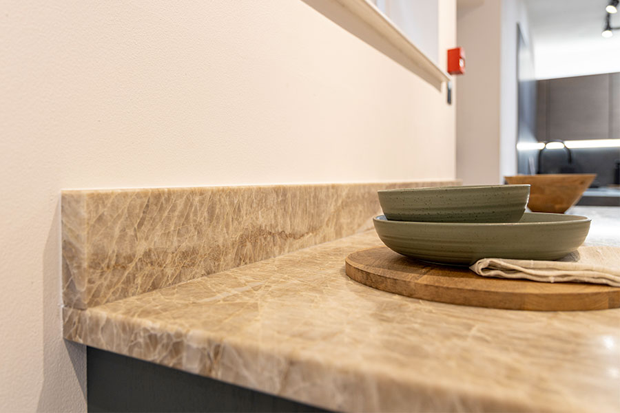 This bespoke Taj Mahal natural quartzite worktop features matched 100mm tall upstands for an elegant finish. The stone worktop was produced by Sussex Stoneworks