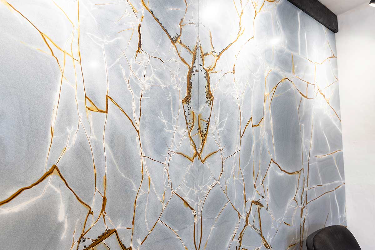 Book-Matched Blue Roma Quartzite stone wall cladding produced by Sussex Stoneworks for the showroom of Claremont Kitchens & Interiors in Midhurst